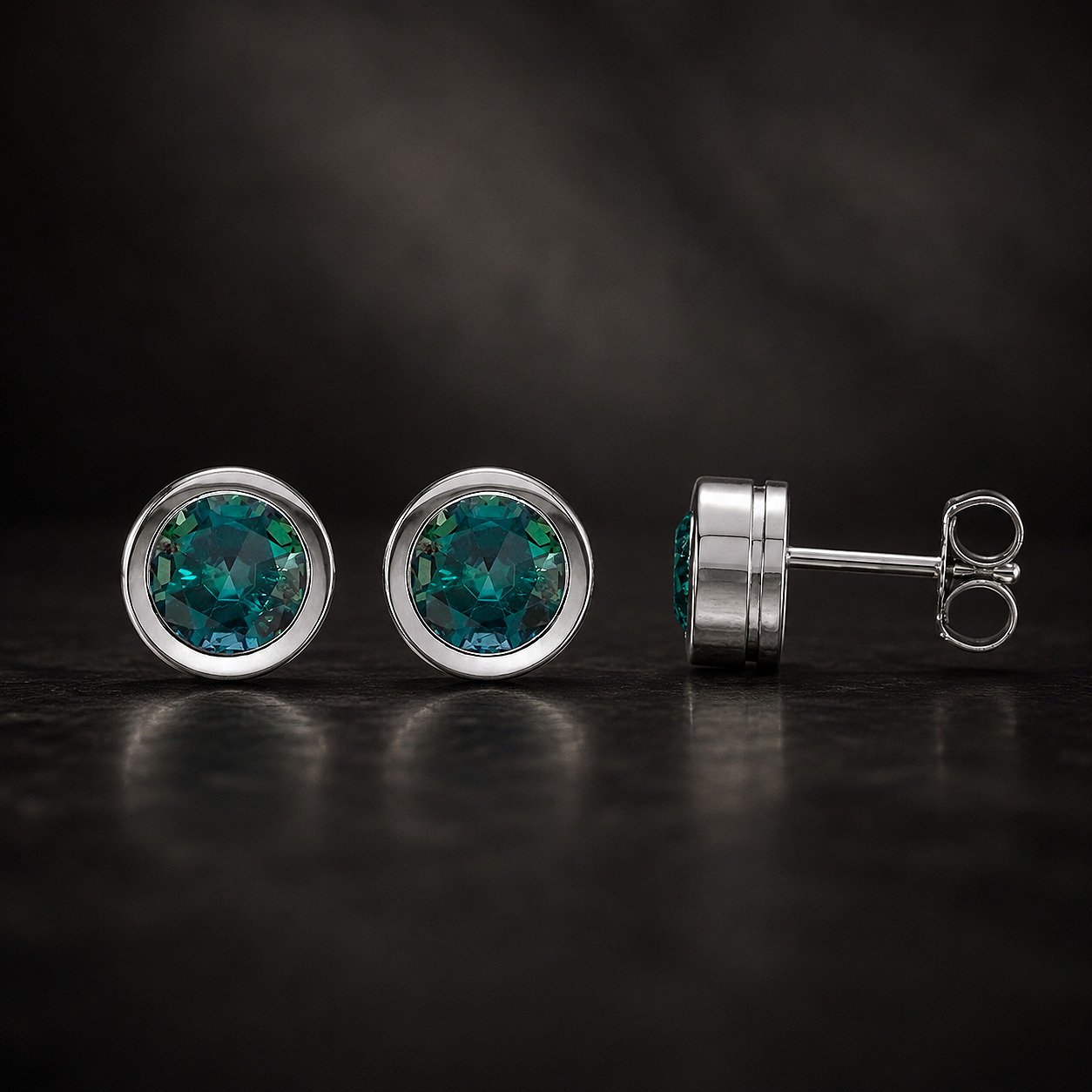 Pair of 6mm lab-grown alexandrite bezel-set stud earrings in rhodium-plated 14K white gold, showing the color-change gemstone.