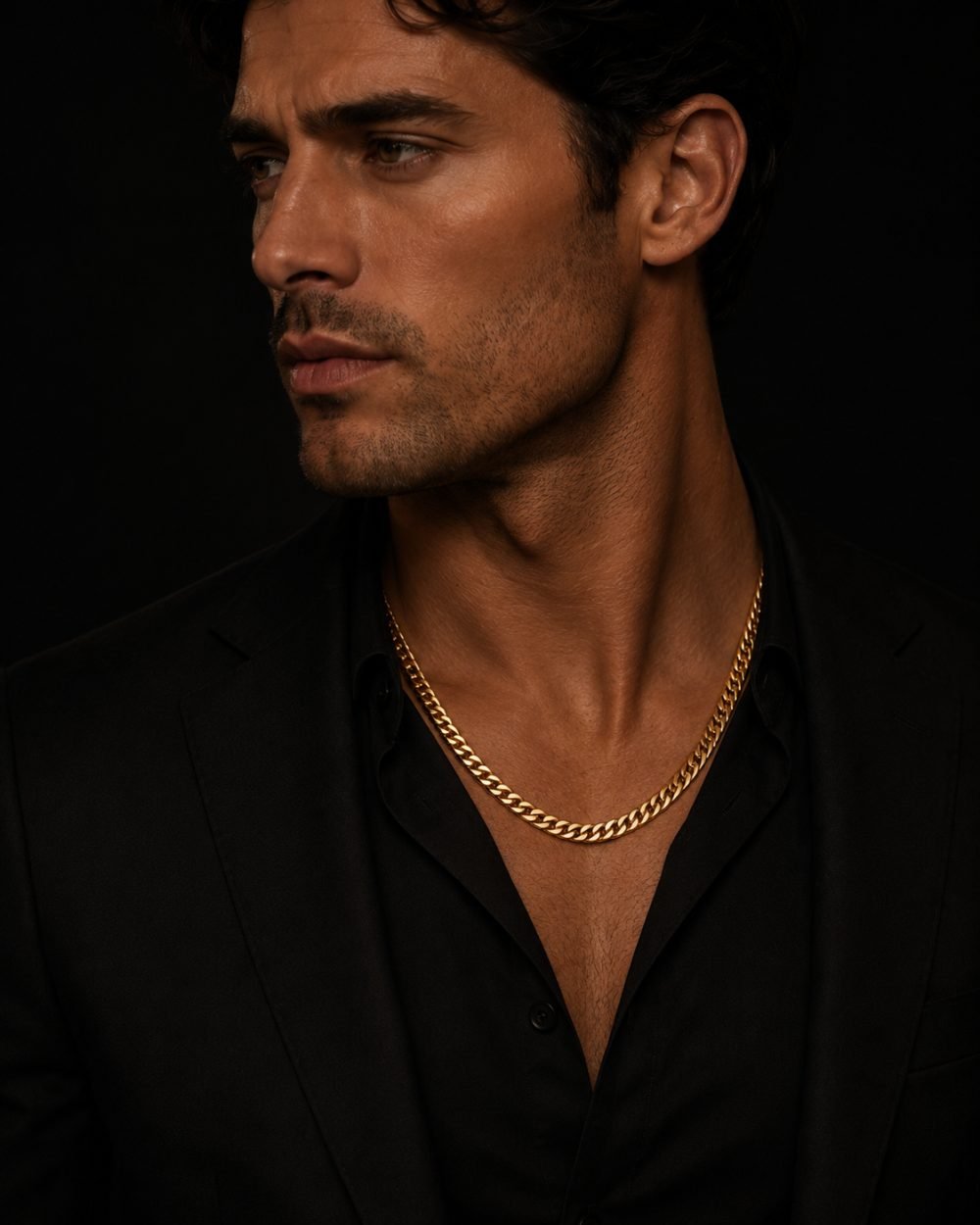 Man in a black suit wearing a gold Cuban chain — The Saint Collection, men's necklaces