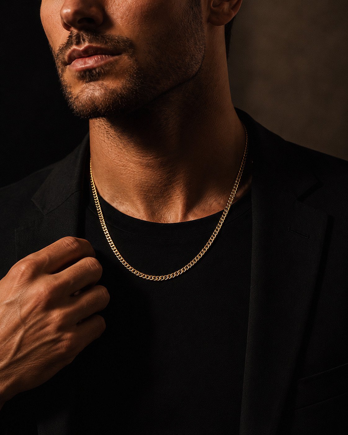 Close-up of a 14K yellow gold 4.4mm Miami Cuban curb chain on a male model.