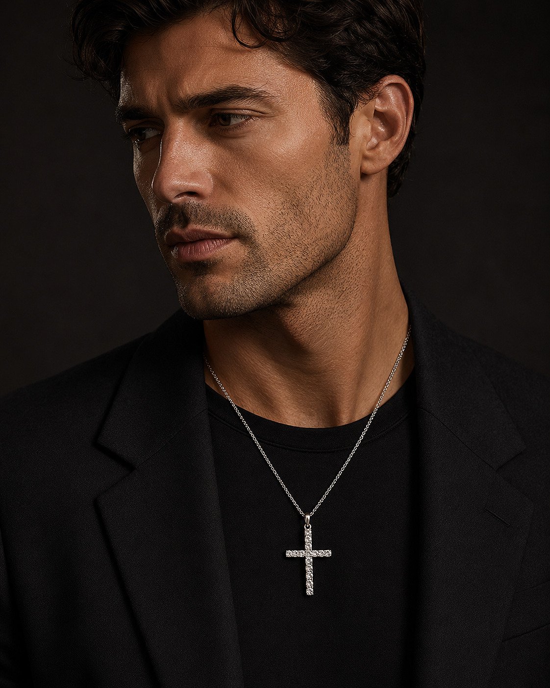 Luxury editorial portrait of a man wearing a 14K white gold diamond cross necklace.