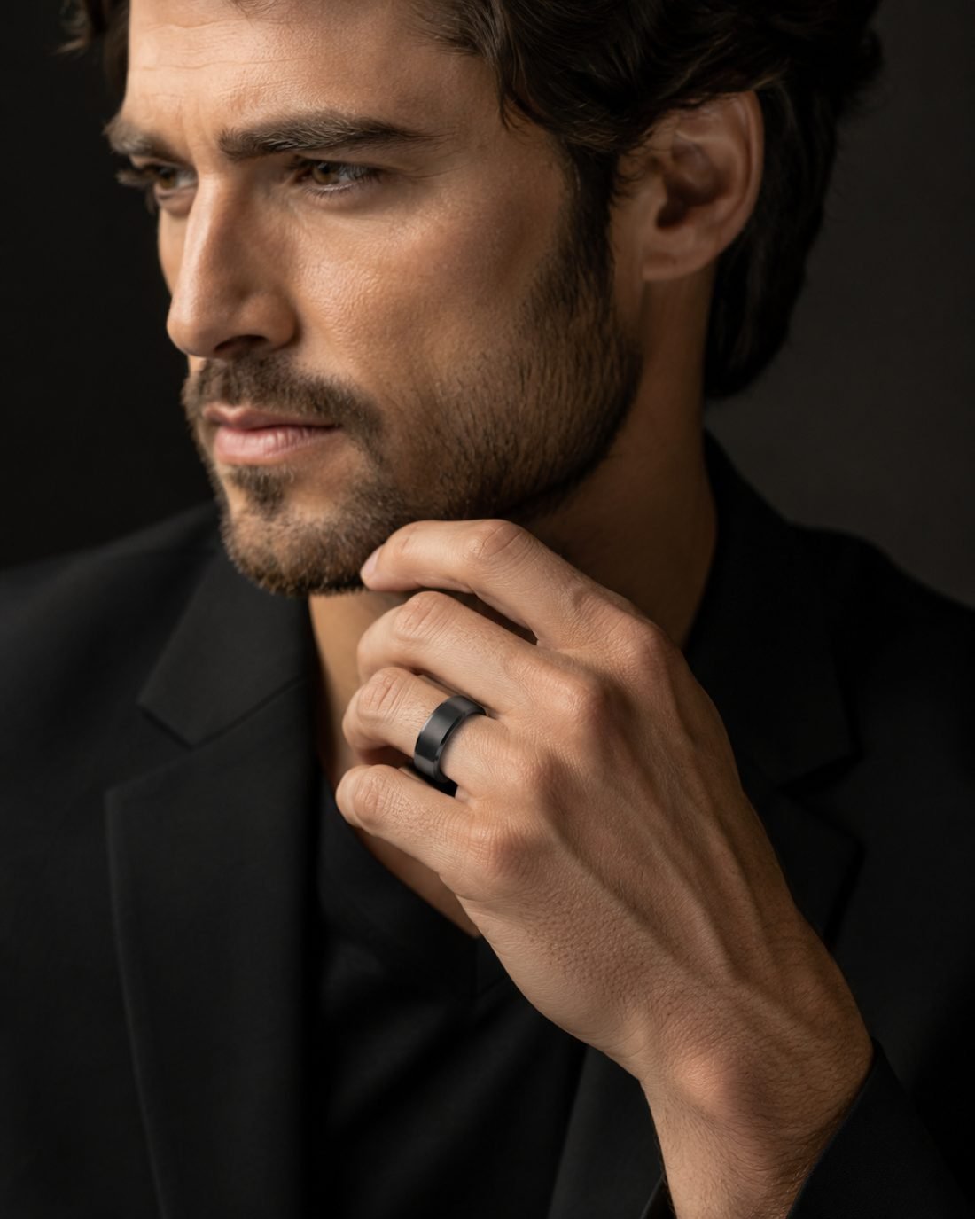 Man in black suit wearing Midori Diamond matte black band ring — the Maison