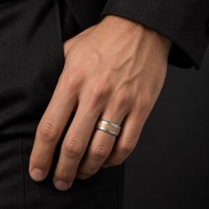 Man wearing a 6 mm tungsten Cypress Band with a pale wood inlay and black tailoring.